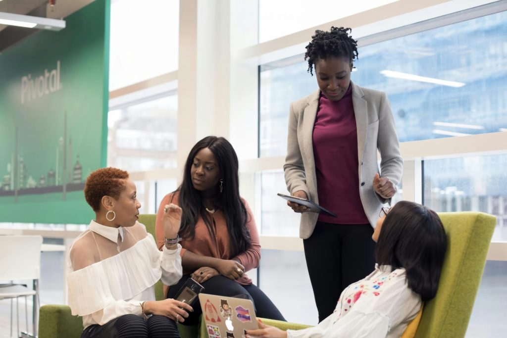 a group of women sitting around each other